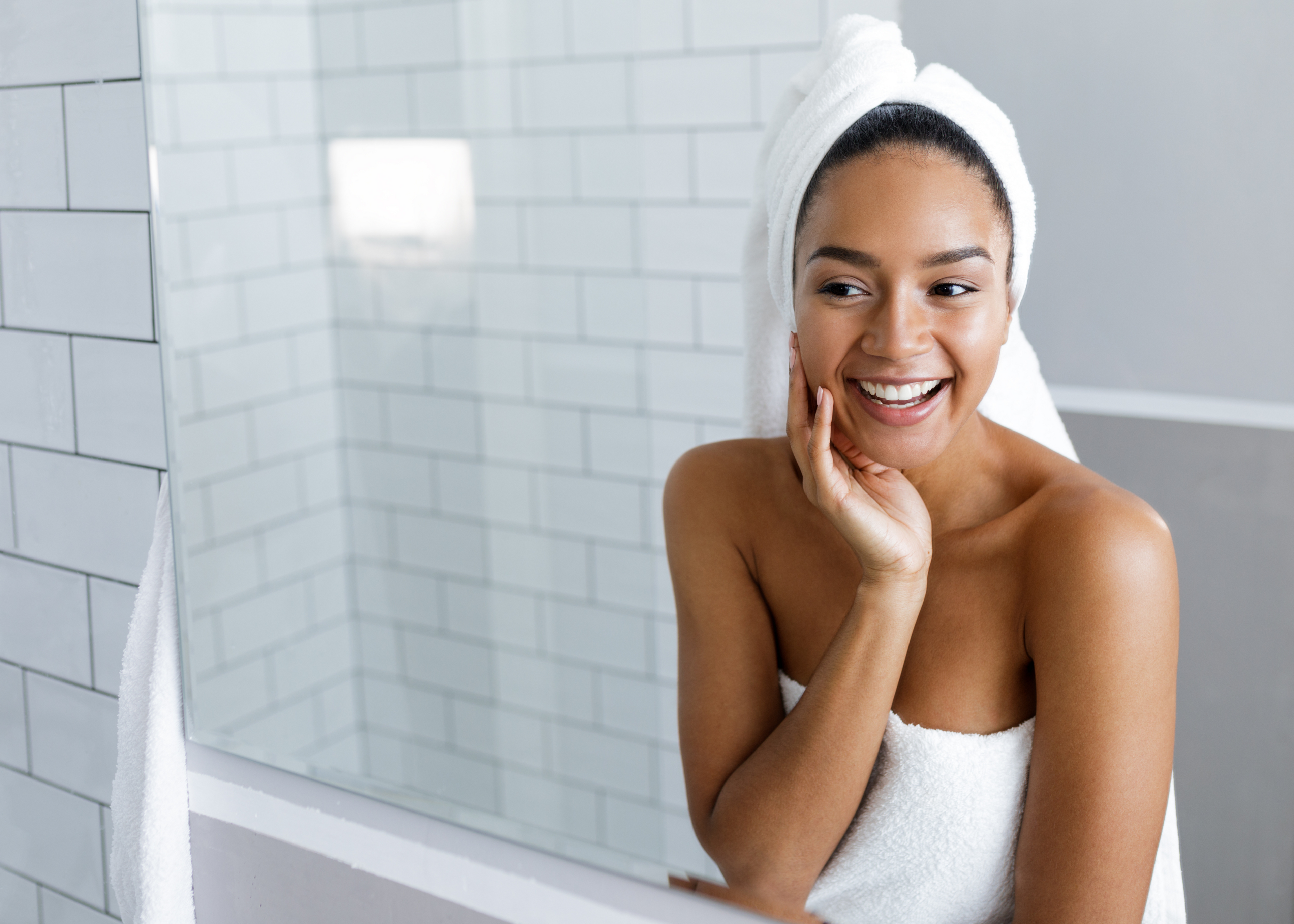 Smiling melanin skin woman after using products for dry skin on face